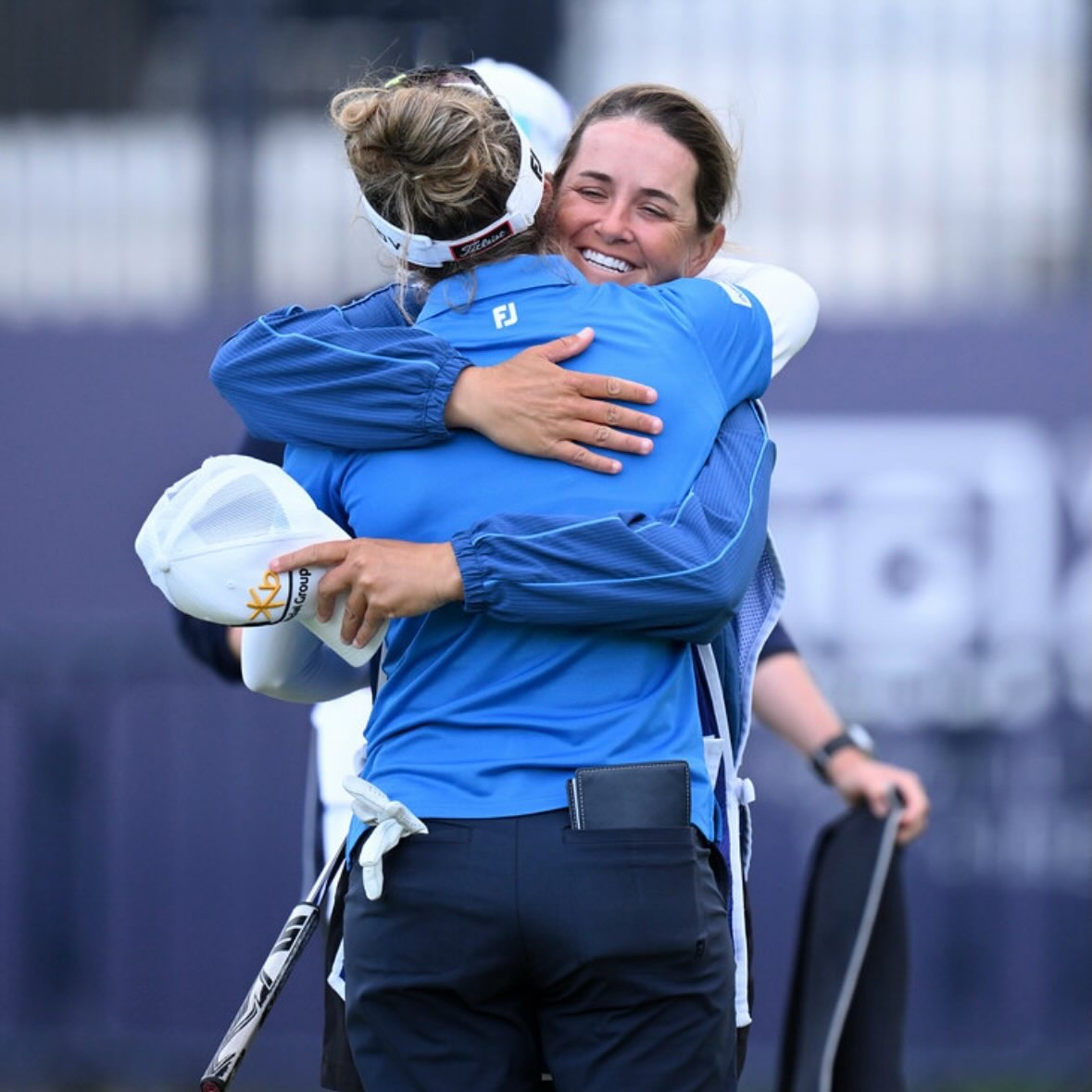 Caddie and player embracing after the final putt