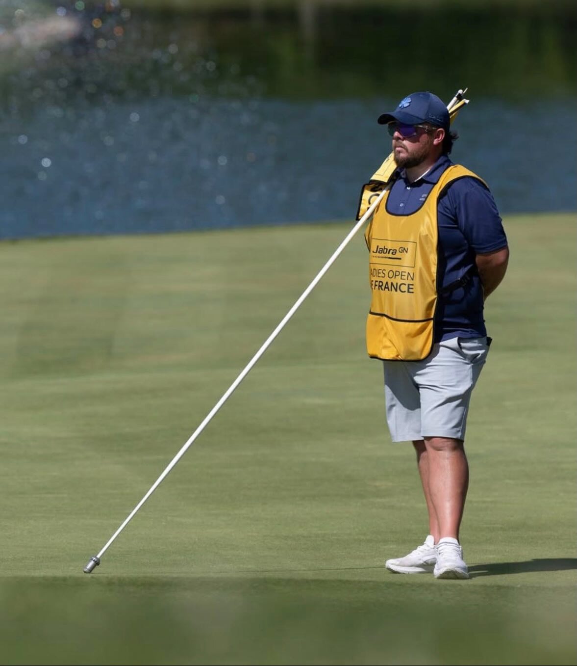 Caddie tending the flagstick at the Jabra Ladies Open de France